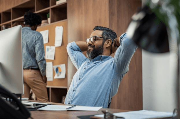 man stretching at his desk